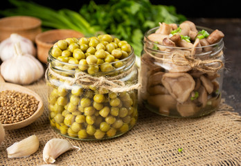 Homemade canned peas in a glass jar. Homemade food. Fermented food. Side view, close-up.