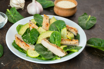 Grilled chicken breast with avocado and herbs on a dark background. Dietary nutrition. Healthy lifestyle. Side view. Close-up.