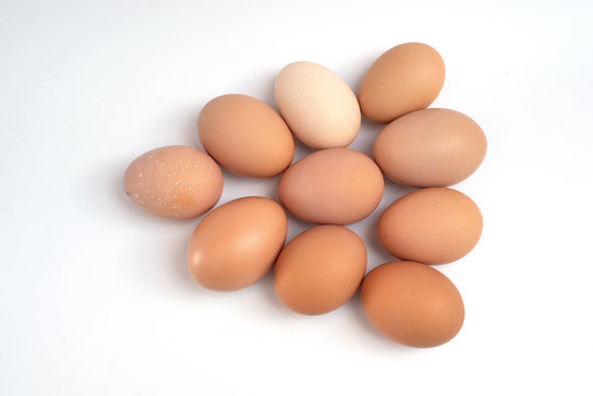 A Dozen Chicken Eggs On A White Background. View From Above