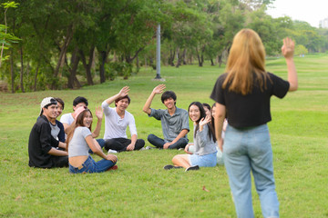 Fototapeta premium Happy young group of friends greeting together at the park