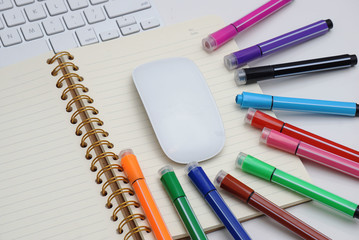 Colored marker pen, book, keyboard and mouse. concepts of home schooling and online schooling.