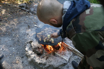 cook in nature, fry meat potatoes on a fire, rest in the forest