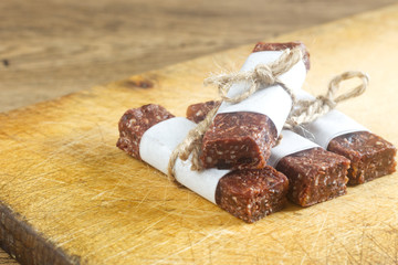 Homemade date bars on the wooden board.
