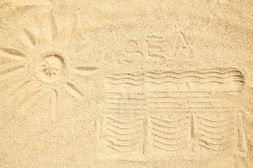 Fototapeta na wymiar A Drawing in the sand near the sea in nature travel background. Hand drawn on vacation.