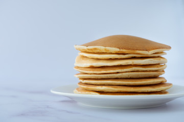 breakfast, pancakes on a white plate on a marble background