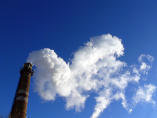 Chimney smoke with blue sky
