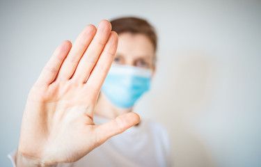 Obraz premium stop coronavirus woman wearing medical mask and raising hand 2019-nCoV fight - spreading