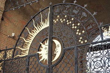 Fragment of the gate of the Syuyumbike tower in Kazan Kremlin close-up. Gates of day & night. Wrought iron gates, with moon and sun. The image of the sun and Crescent moon on the gate. Kazan. Russia