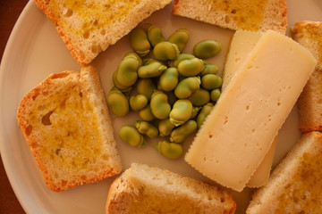 homemade bread with  extra virgin olive oil, fava beans and cheese