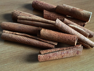 Concept of spices collection, cinnamon sticks on a wooden background
