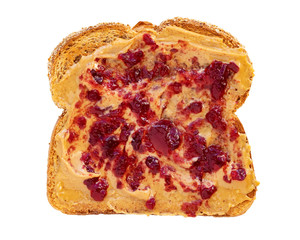 Creamy peanut butter spread with fruit jam on healthy whole wheat toast bread, isolated on white background, photographed from above