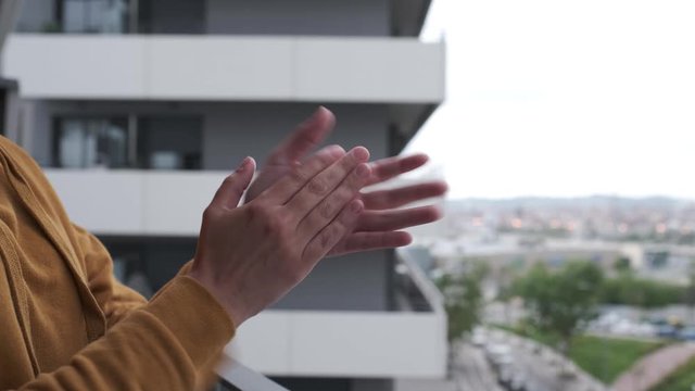 Woman hands in Spain clapping hands/applauding on her balcony in support of public health system - coronavirus crisis
