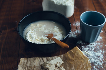 Bowl with water and flour to make sourdough. Bakery concept.