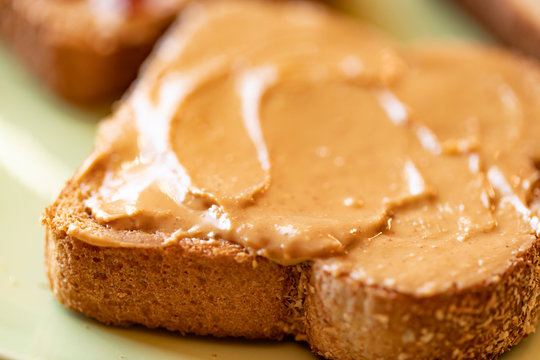 Creamy peanut butter spread on healthy whole wheat toast bread