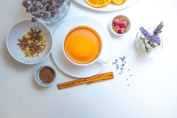 still life of medicinal herbs and a mug of herbal tea