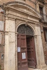 Siena ghetto, alley with the Synagogue of Siena, Tuscany, Italy. Old narrow alley with underpass and arches in the historic city center