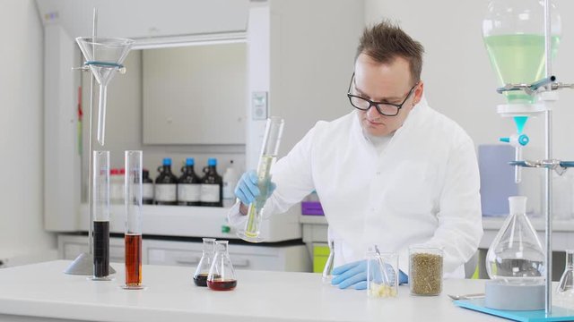 Chemist working with hemp CBD oil in laboratory