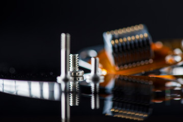 Cogs for assembling a computer, photographed close-up with a blurred background.