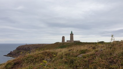 Fototapeta na wymiar A Coastal Lighthouse In Heathland Near The Sea 