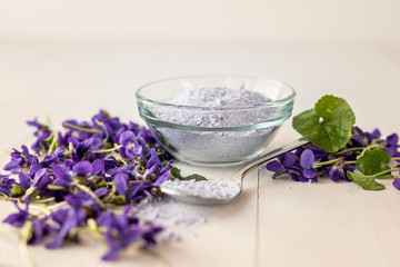 Obraz na płótnie Canvas close up lilac sweet sugar crystals bath salts from fresh viola violet violetta odorata blossom flowers 
