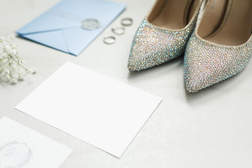 Wedding details. envelope, invitation, wedding rings and a bouquet of flowers, shoes of the bride.