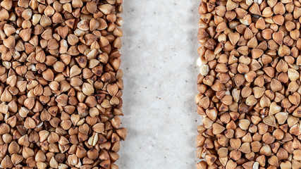 Essential goods: Buckwheat. Buckwheat seed pour in bunch closeup. Buckwheat cereal background.