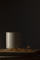 Corn kernels on a wooden table with a white metal