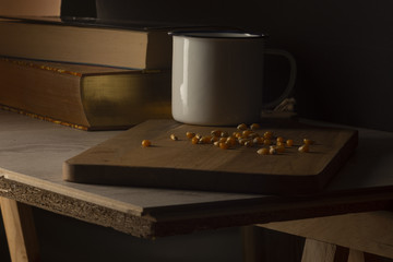 Corn kernels on a wooden table with a white metal