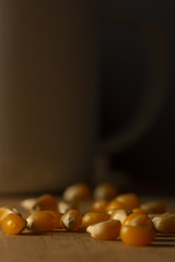 Corn kernels on a wooden table with a white metal