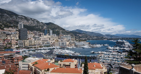 Fototapeta na wymiar Monte Carlo, Monaco - April 2017: The marina and hills