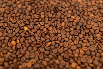 Roasted coffee beans as a background. Coffee beans creative background for advertising. Coffee beans texture. Small depth of field.