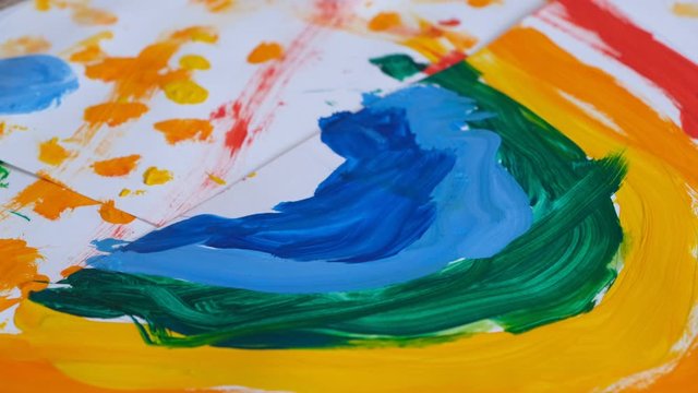 young diverse children paint colorful space pictures together on paper using paint brushes happy kids enjoying fun creativity painting science fiction space drawing pictures top view