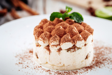 Gourmet sponge cake with chocolate sprinkles and mint, horizontal