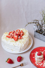 Torte und Törtchen mit Quark und Sahne und weißer Schokolade und Erdbeeren