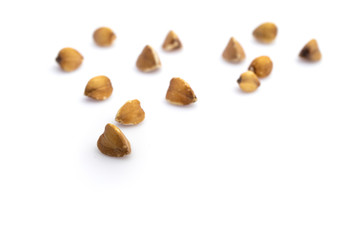 Buckwheat background. Brown organic raw seeds isolated on white. Cereal grains - vegetarian nutrition food. Vegan gluten-free organic, healthy diet superfood with antioxidant, mineral nutrients.
