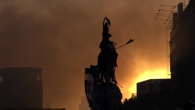 Hundreds of people protest at the main Plaza Baquedano monument in Santiago of Chile