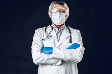 Male doctor wearing protective Mask and Goggles. Dark background. Close up.