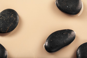 Massage spa stones close up in wavy water background