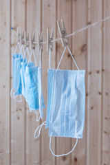 Disposable medical masks hang on a clothesline. Concept. Reuse. Deficit