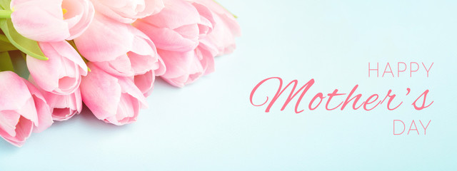 Tender pink tulips on blue background. Happy Mother's Day greeting card, banner for website.
