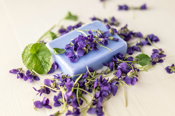 Obraz na płótnie Canvas viola violetta odorata skin care product fragrant lilac soap with lilac spa bath salts and tincture body oil 