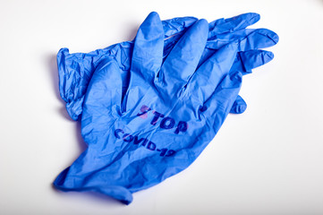 hand medical rubber glove with the inscription stop covid19