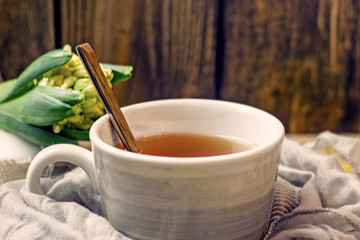 Transparent cup of tea with honey spoon