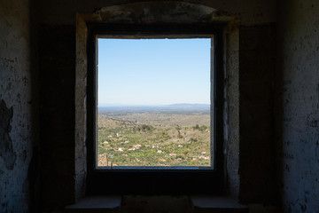 View of Castelo de Video Serra de Sao Mamede mountains landscape through the window of the castle, in Portugal