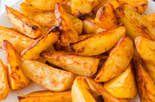 Golden Spicy Potato Wedges Fried Or Oven Baked Closeup.