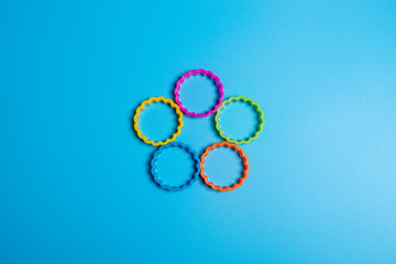 Five multi-colored plastic cookie cutter for making cookies on a blue background. Culinary concept....