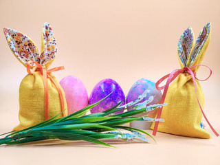 Easter Bunny and Easter bags on a beige background.