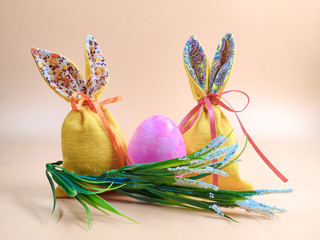 Easter Bunny and Easter bags on a beige background.