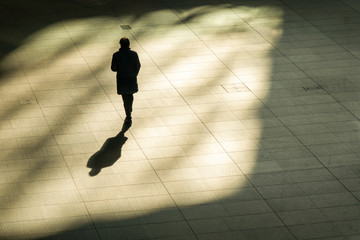 top aerial view of businessman walk and hold briefcase in work time at pedestrian. with lighting...
