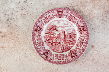 Antique porcelain dish on concrete background.